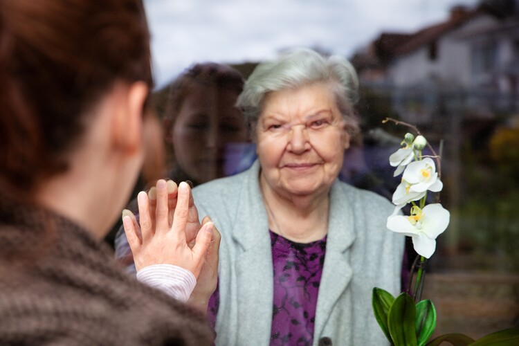 granddaughter visits grandmother, separated only by glass. write in your covid diary about visiting loved ones