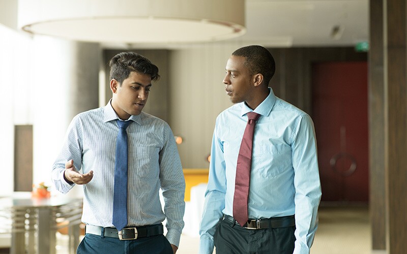 Man showing empathy to a coworker telling a difficult story.