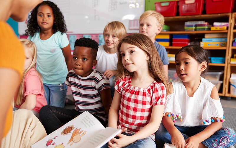 Children practicing active listening skills while listening to a story.