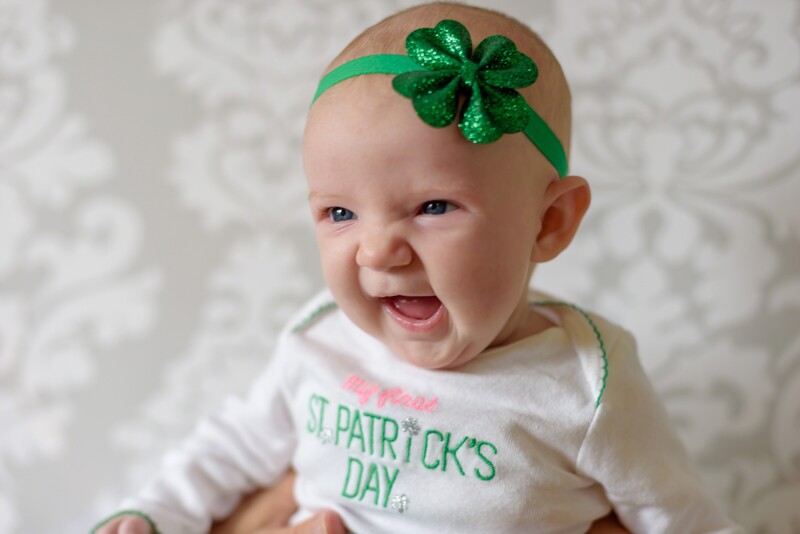 a little girl with a shamrock headband