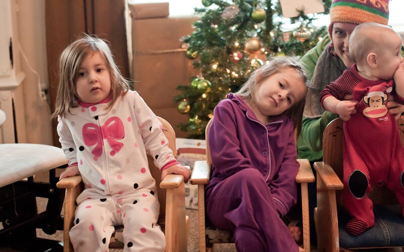 two girls celebrate pajama day, a holiday tradition held by a family.