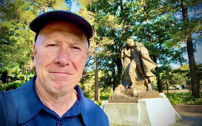 Kevin Mitchell with a statue of the pioneers.