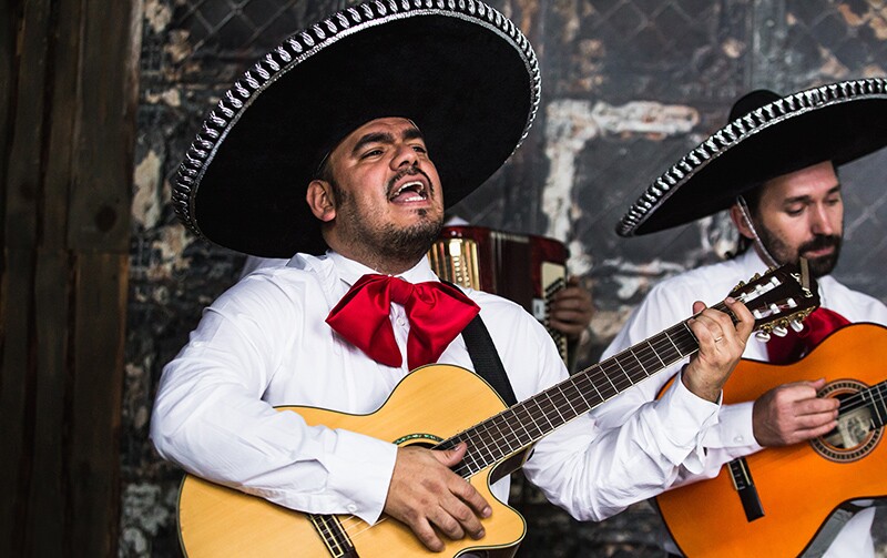 Two Mexicans sing and play their guitar. Mexican heritage
