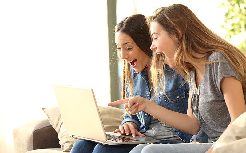 two girls on a computer.