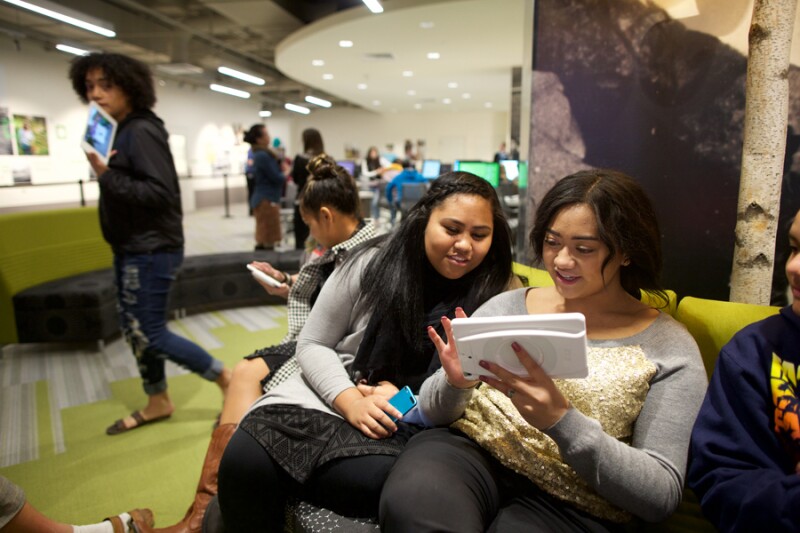two women looking at ipad in Family History Library discovery center