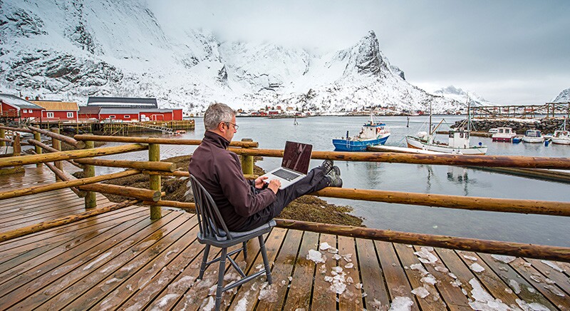 a norwegian man on a computer who may be doing norwegian genealogy research.