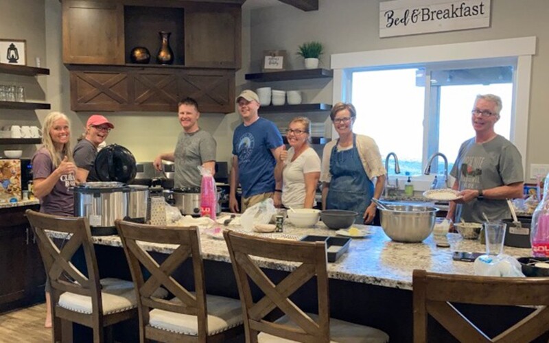 A photo of Camille's family in the kitchen having family dinner.