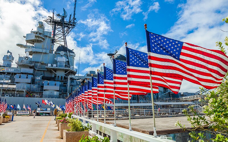 U.S. flags displayed outside the Missouri Warship Memorial in Hawaii for Pearl Harbor Remembrance Day.