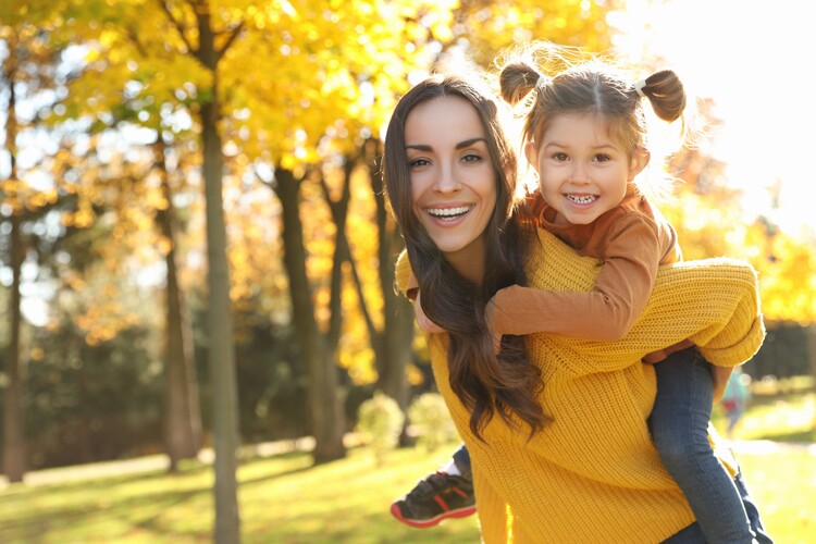 A mother and daughter play at the park