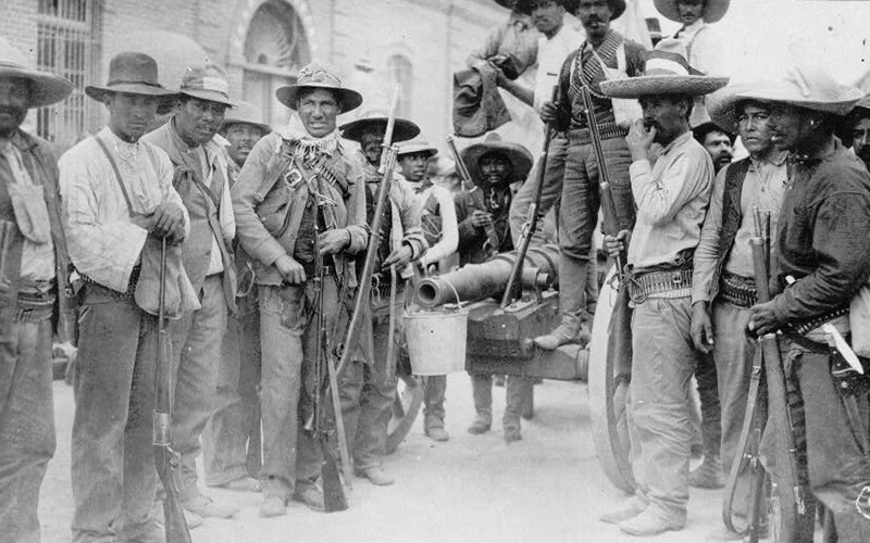 Black and white image from Mexico's colonial era of men holding guns.