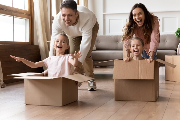 a family, including a father, mother, and two children, play together.