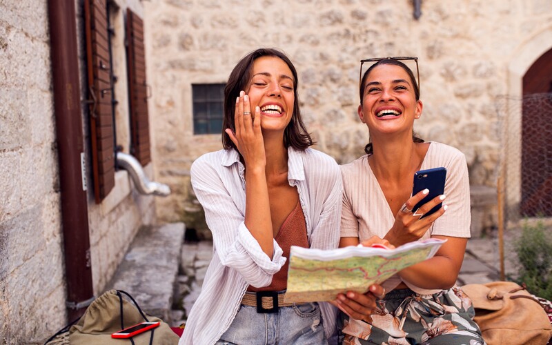 Two sisters travel to Italy and hold a map in their hand