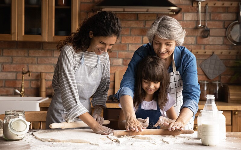 Grandmother teaches daughter and granddaughter a family cookie recipe.