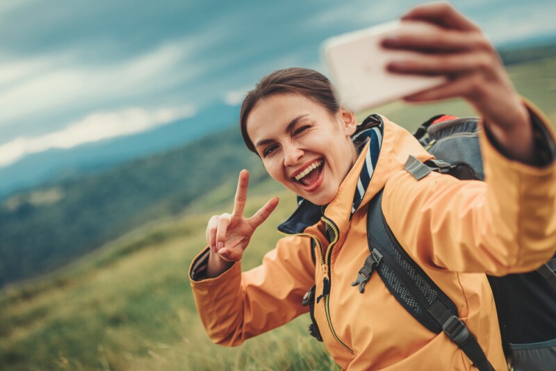 Millennial woman taking selfie with phone
