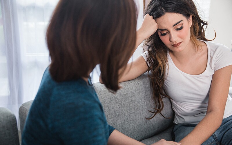 Friend showing empathy as she listens to her sad friend.