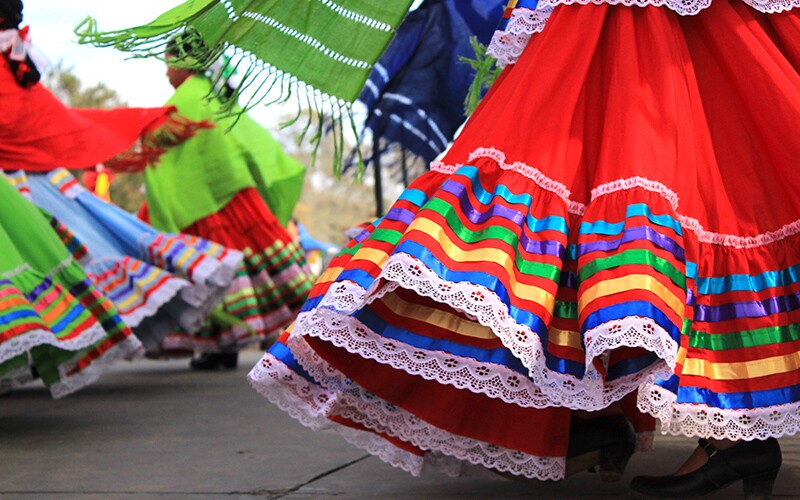 Colorful skirts moving with the dancers in the Mexican tradition called the Mexican hat dance