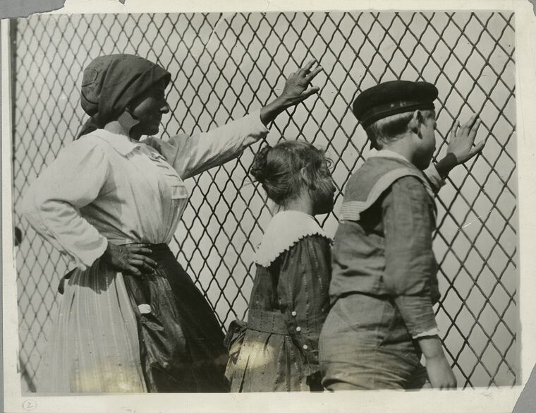 US immigrants putting hands on fence