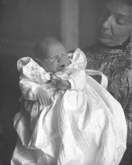 An infant in a white dress. Photo likely taken in the 19th century.