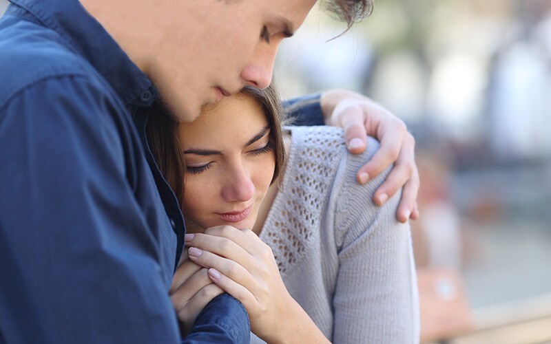 A husband helps his wife cope with grief after loss.