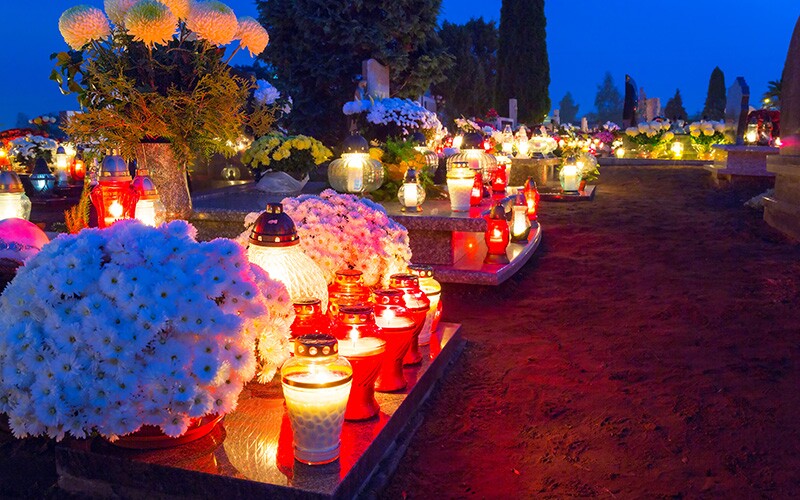 In Poland, people celebrate All Souls' Day by visiting their ancestors' graves and lighting candles.