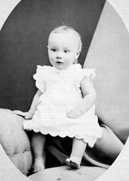 2-year-old boy wearing a white dress in 1880