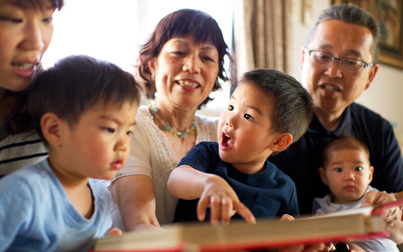 family holds babies and looks at photos