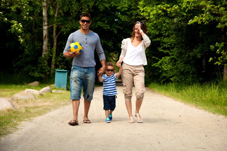 a puerto rican family walks on a path together. 