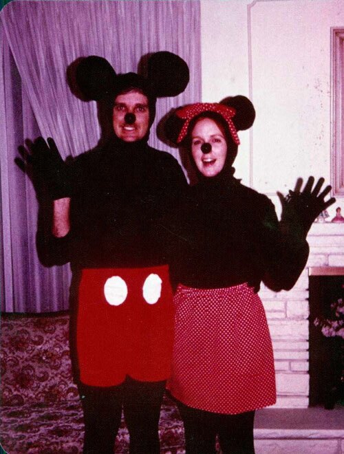 Couple dressed as vintage Mickey and Minnie mouse for Halloween.