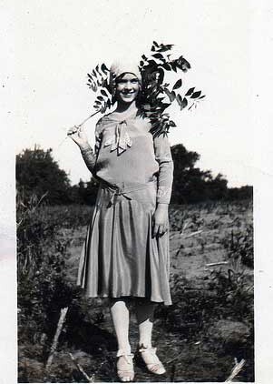 Women donning 1930s fashion dress and hat