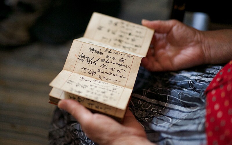 a person looks at a japanese record.