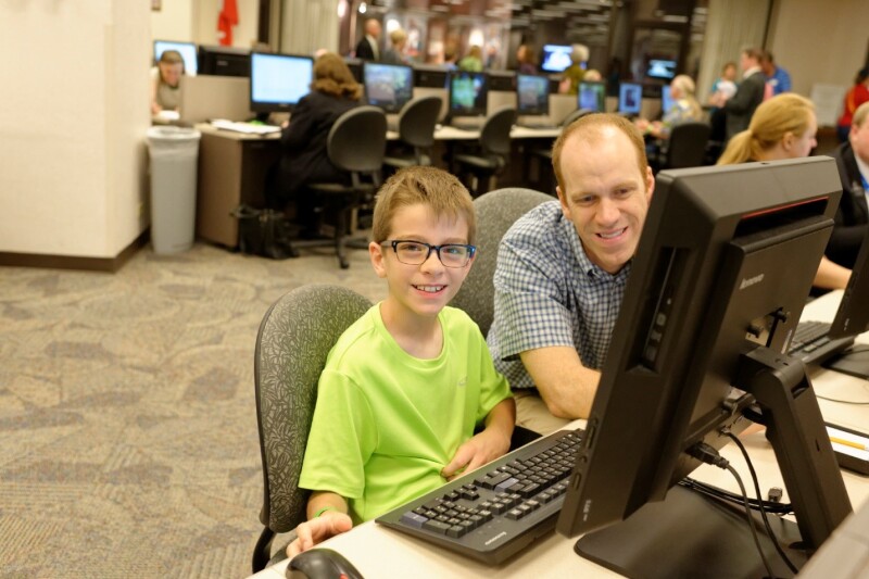 father and son doing family history at the FHL block party