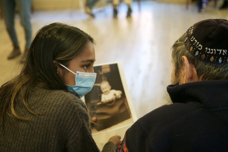 Woman listening to elderly man tell stories.