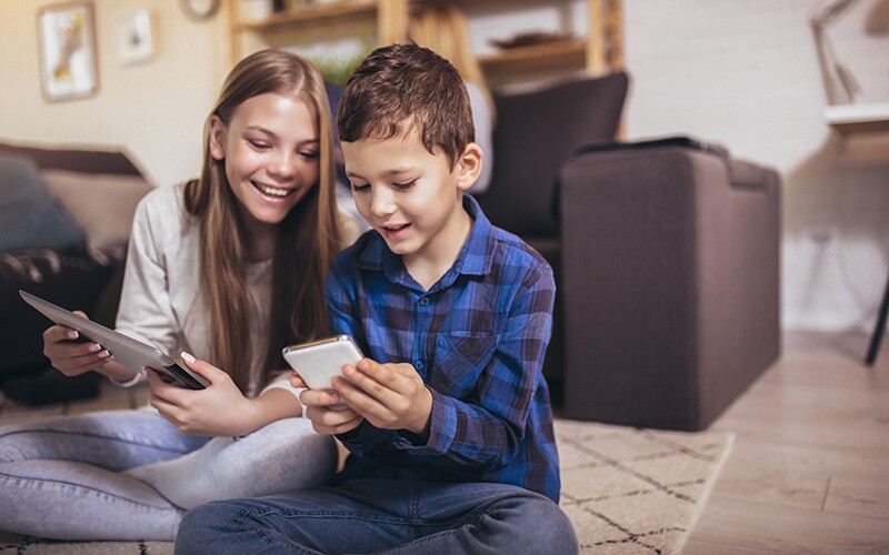 Kids indexing for FamilySearch using the new mobile app in 2022.