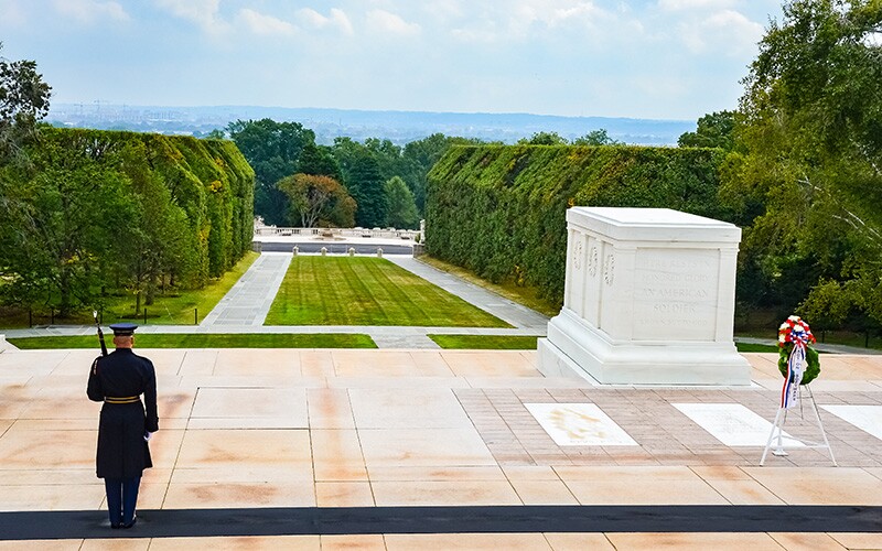 A guard stands watching over the tomb of the unknown soldier.