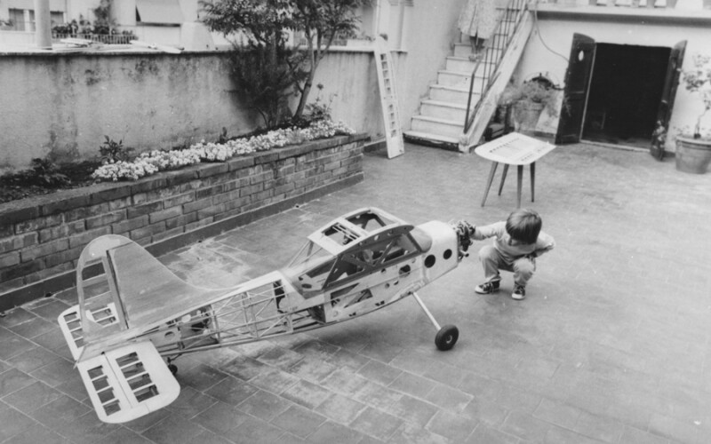 boy in the 1950s examining a small plane