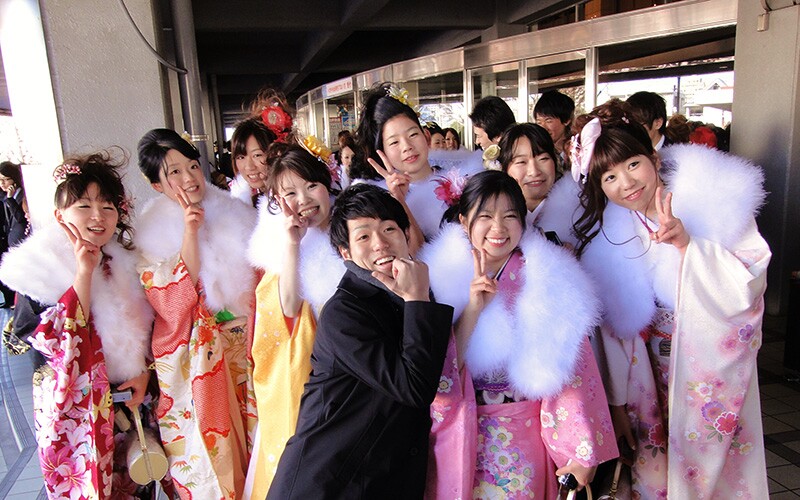 several japanese young adults at coming of age day, a japanese cultural celebration.