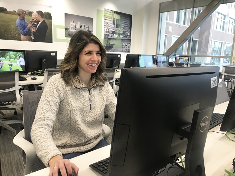 Girl smiles at computer