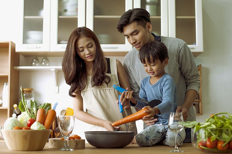 a family completes a new year resolution idea by cooking together.