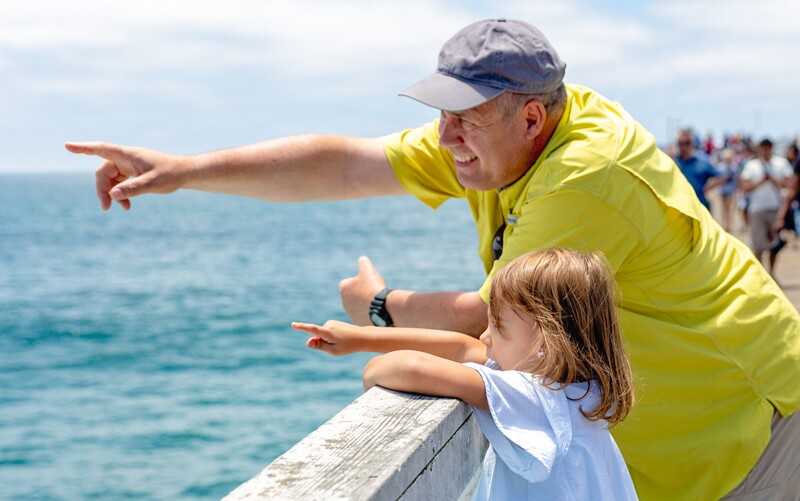 Grandfather with granddaughter by the water