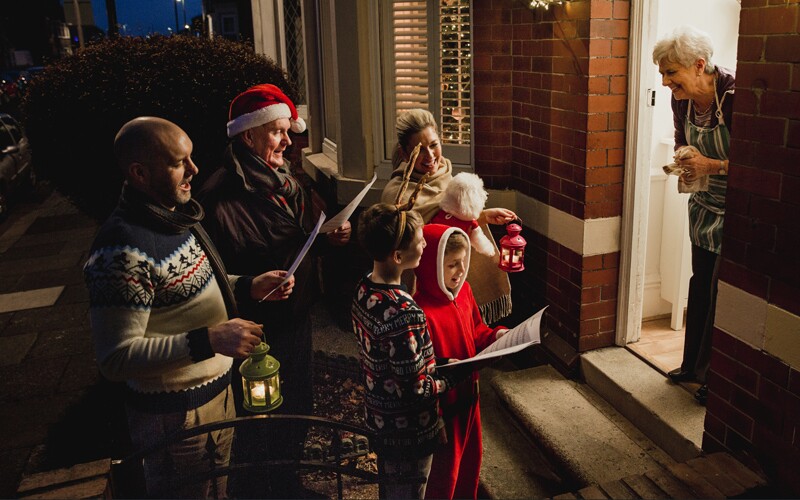 a group goes holiday caroling.