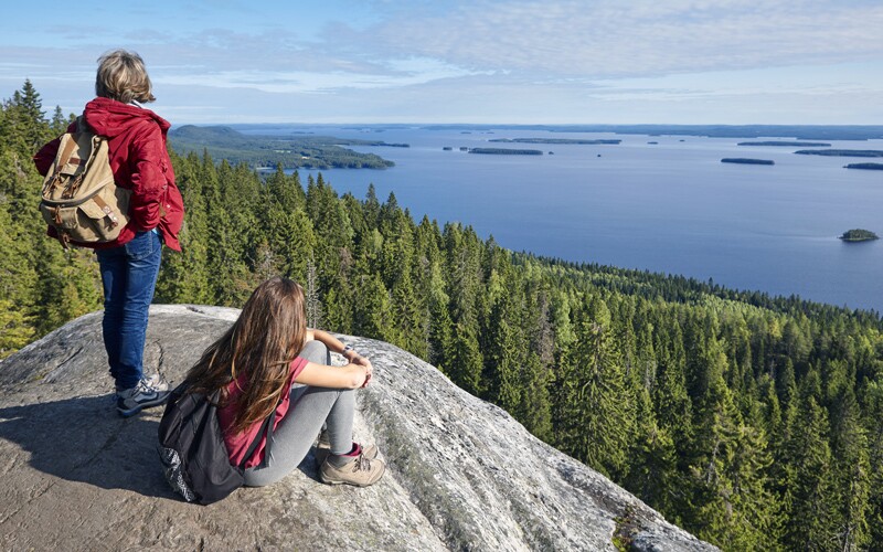 Koli National Park. Woman and girl sitting on rock