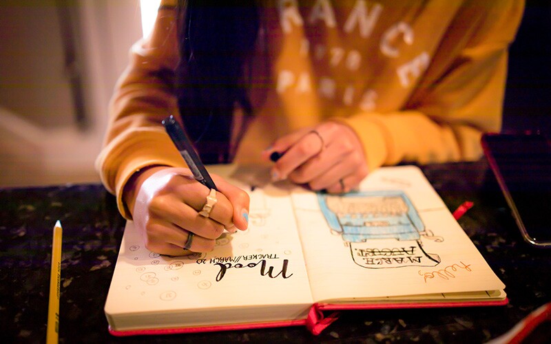 Woman writing in a bullet journal