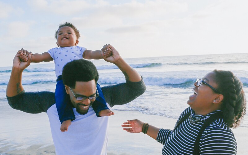 a family celebrates together on a beach.