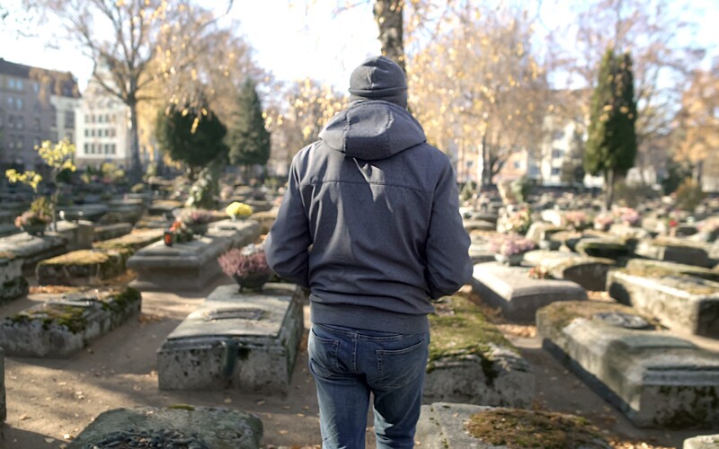 A man walks through a graveyard on a heritage tour