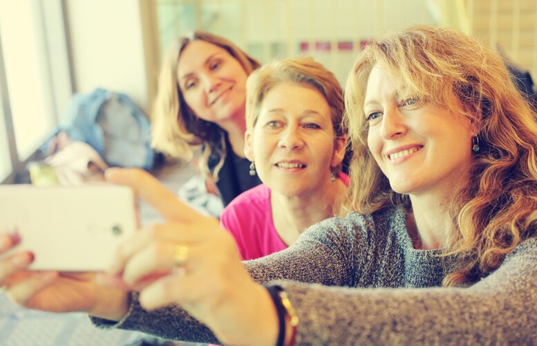 group of generation x women taking a selfie