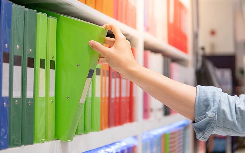 Woman uses office supply store gift card to buy supplies for genealogy ventures.