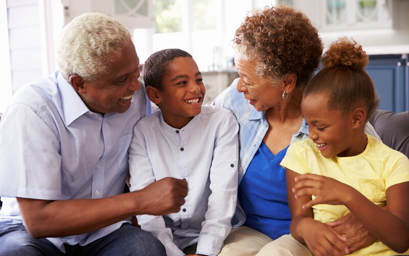 african american grandparents speak with their grandchildren.