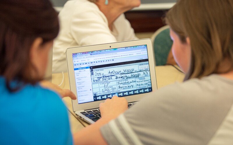 Two women looking at web indexing interface on FamilySearch.org.
