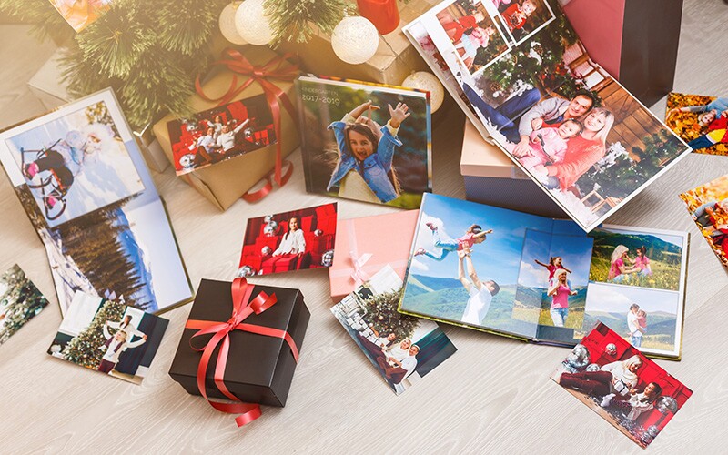 Photo albums and other genealogy gifts under a Christmas tree.