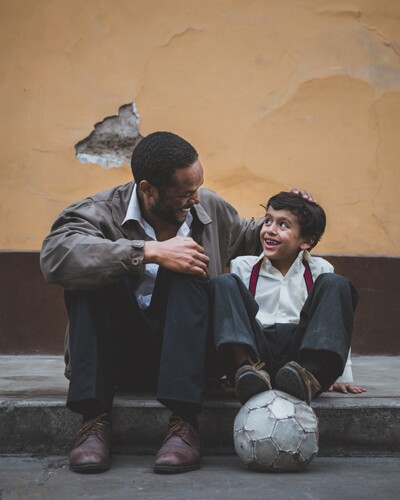 A Father and son on the sidewalk together